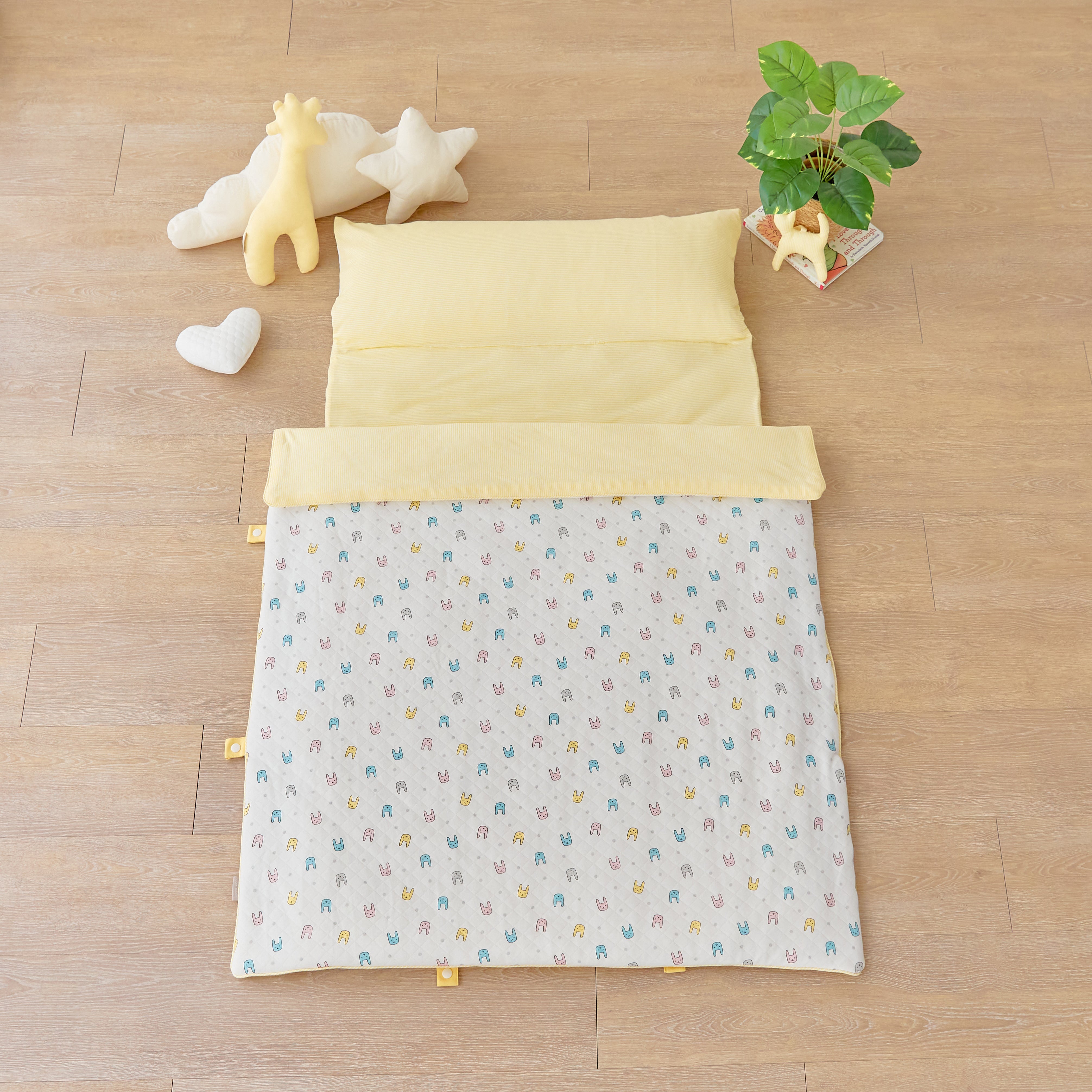 Day Care Portable Cotton Nap Mat Blanket in colorful bunny Rabbit Stripe pattern on wooden floor
