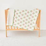 Wooden crib with strawberry print kniited cotton and minky baby stroller blanket 