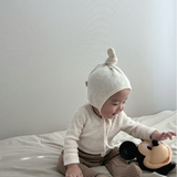 Baby wearing Cloud Soft Ivory Rib Knit Sweater styled with neutral leggings