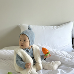 Baby wearing Cloud Soft Rib Knit Sweater styled with neutral leggings and dumble vest for cozy winter styling