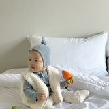 Baby wearing Cloud Soft Rib Knit Sweater styled with neutral leggings and dumble vest for cozy winter styling