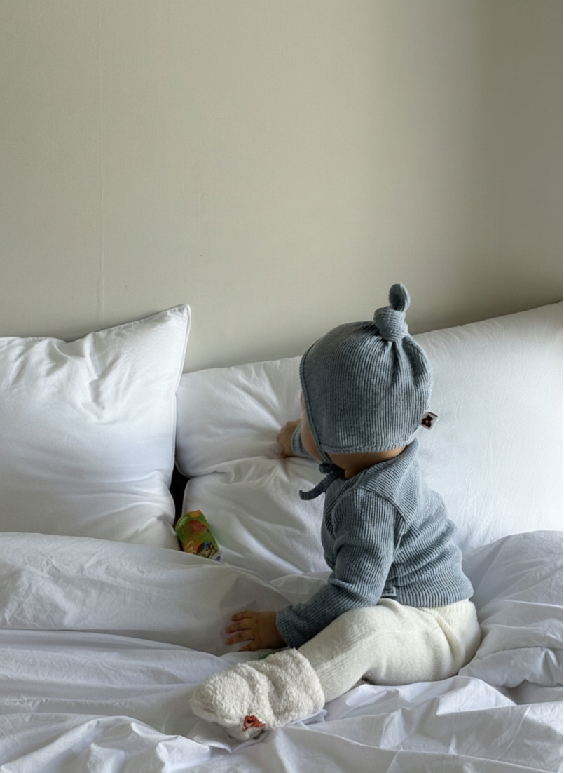 Baby wearing Cloud Soft Rib Knit Soft Blue Sweater styled with neutral leggings