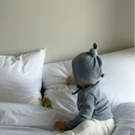 Baby wearing Cloud Soft Rib Knit Soft Blue Sweater styled with neutral leggings