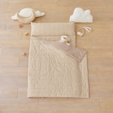 kid's nap mat blanket on wooden floor in brown tan beige checkered pattern