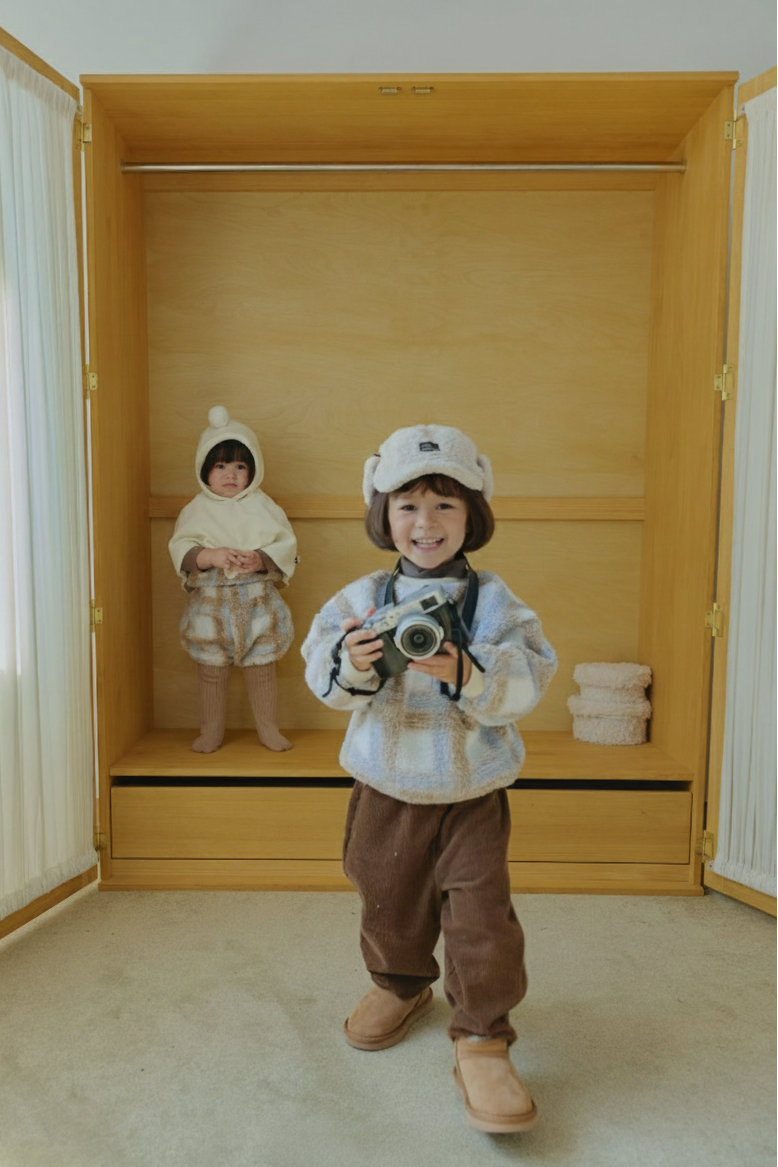 Toddler wearing Cloud Dumble Sweater Soft Check and brown corduroy cargo pants indoors for cozy fall and winter wear