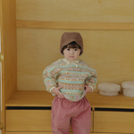 Baby wearing Corduroy Comfort Pink Pants paired with pink green sweater top for winter outfit