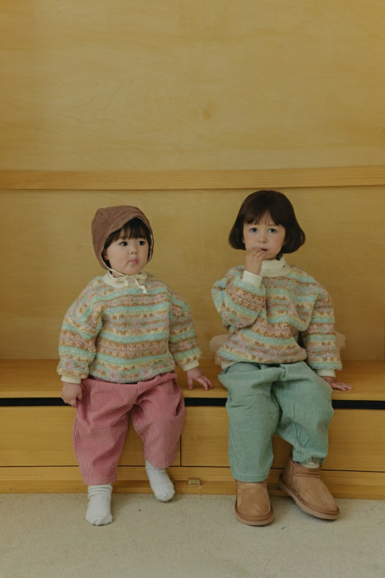 Toddlers wearing Corduroy Comfort Pants pink and sage green paired with neutral top for winter outfit