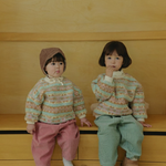Toddlers wearing Corduroy Comfort Pants pink and sage green paired with neutral top for winter outfit