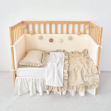 Cozy reversible beige gingham stroller blanket with ruffle trim and sherpa backing