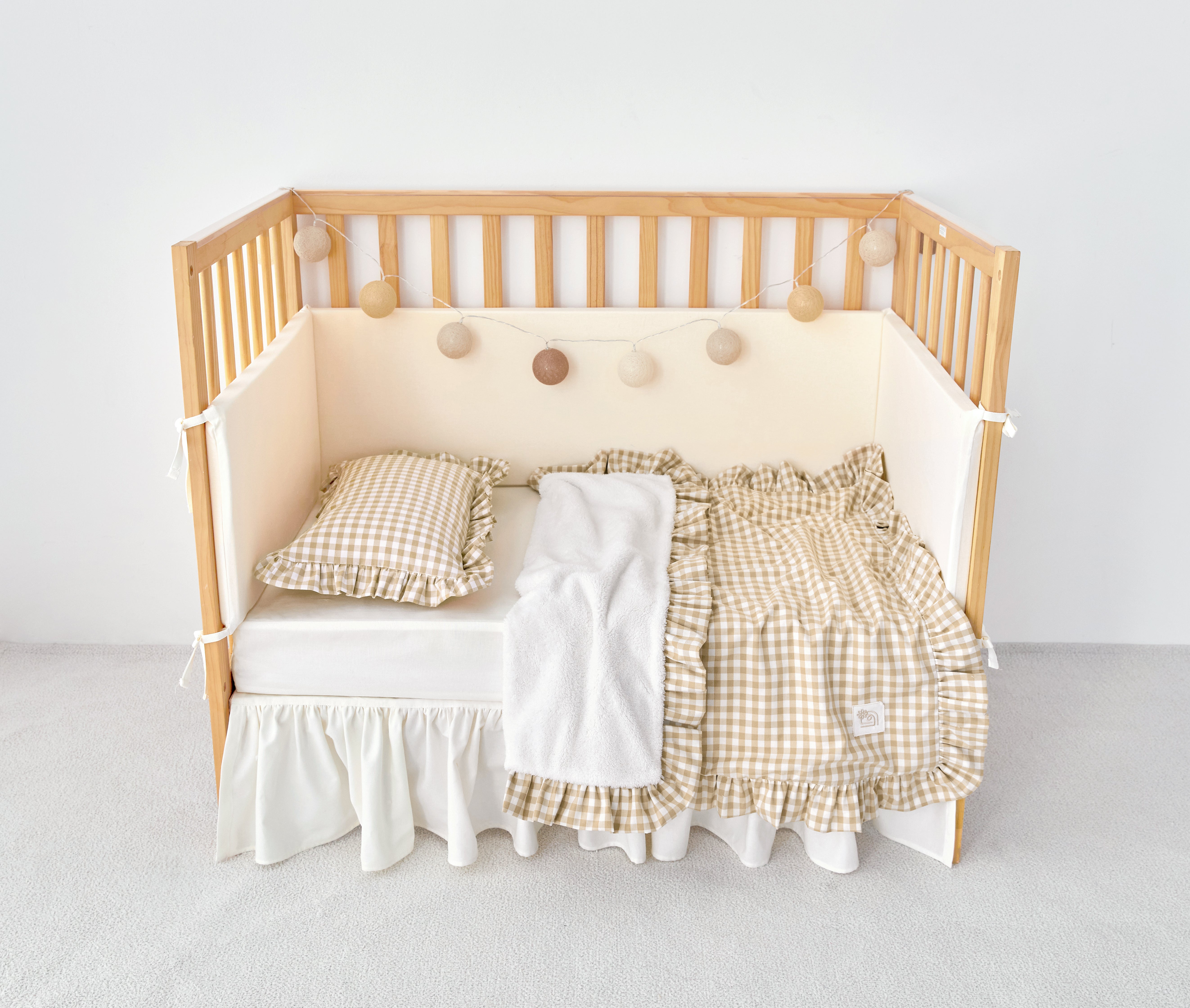 Cozy reversible beige gingham stroller blanket with ruffle trim and sherpa backing