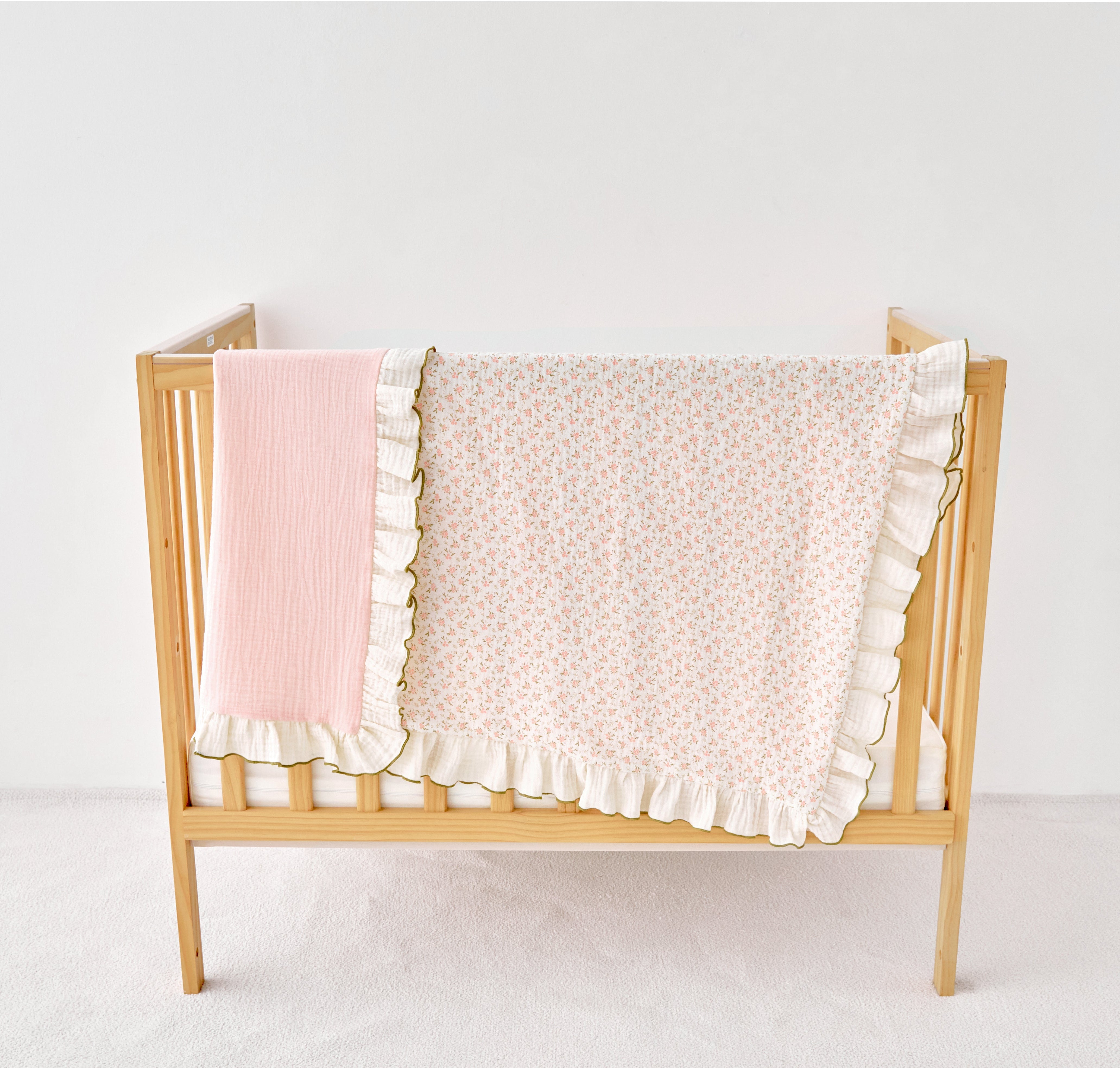 pink olive green ruffled blankets on a white background